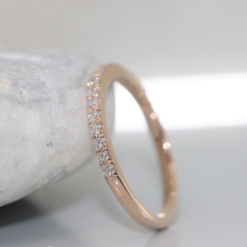 pave set diamond eternity ring in 14k rose gold