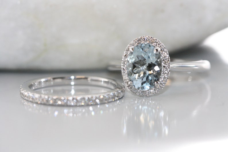 Halo diamond and aqumarine bridal rings